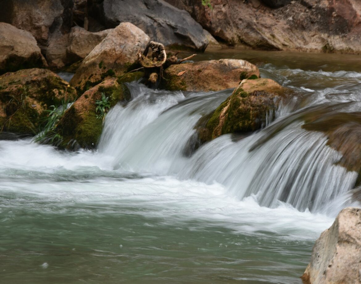 water falls on brown rock